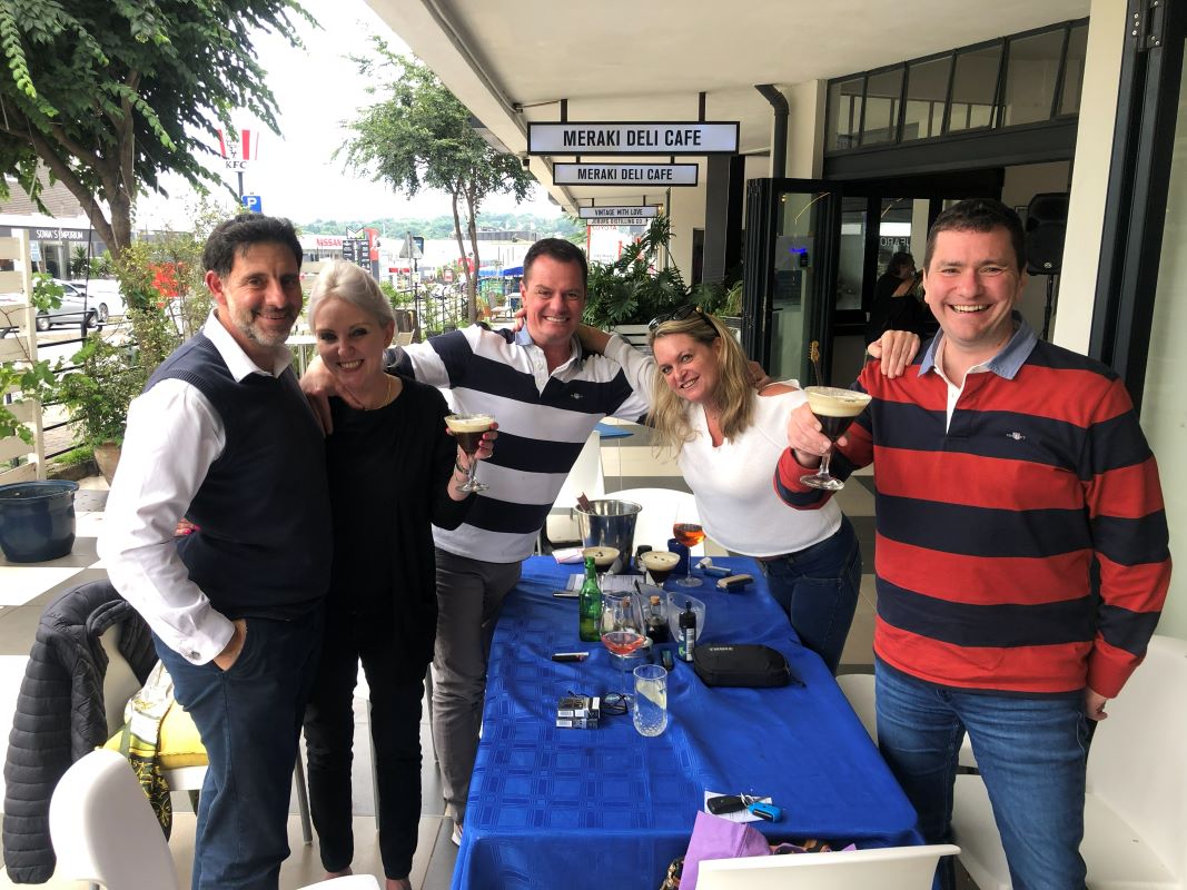Friends toasting espresso martinis outside