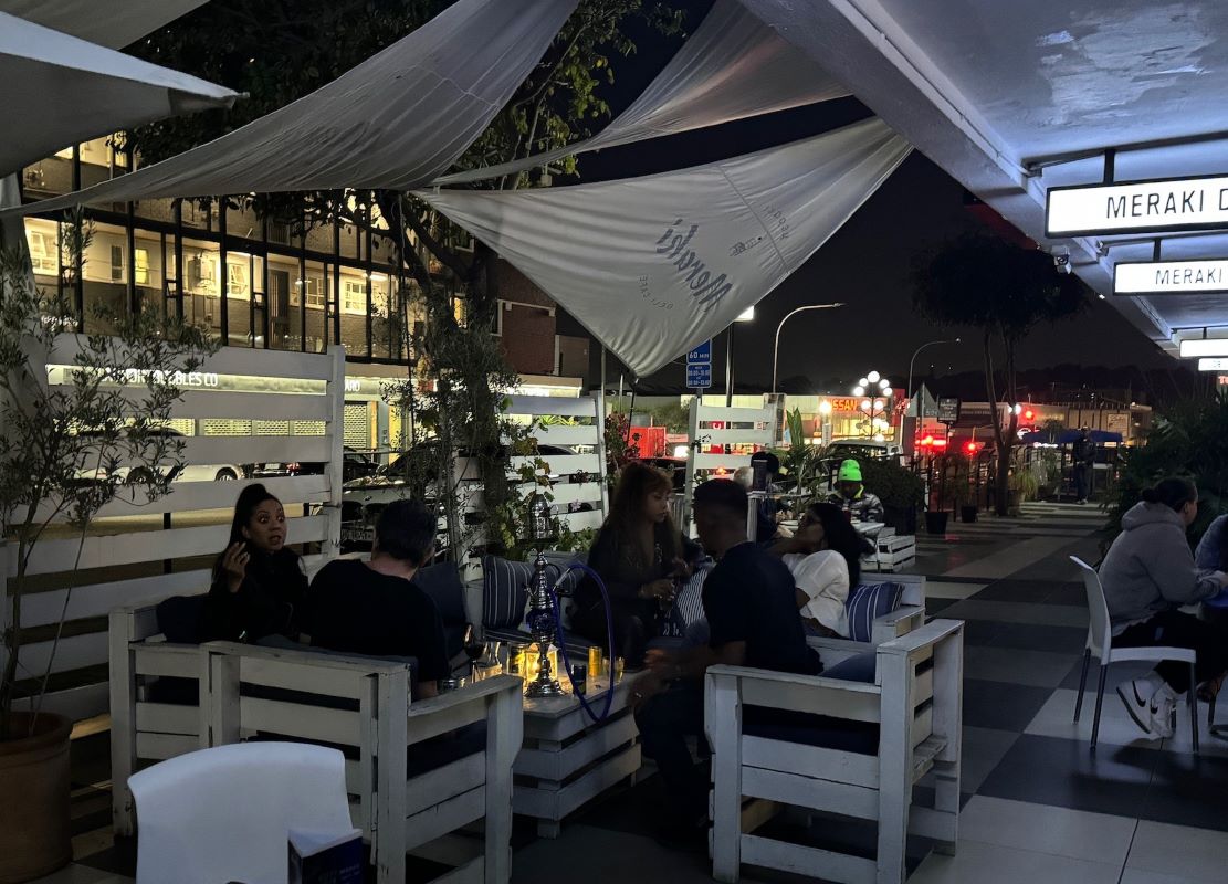 Guests relaxing on the terrace at night