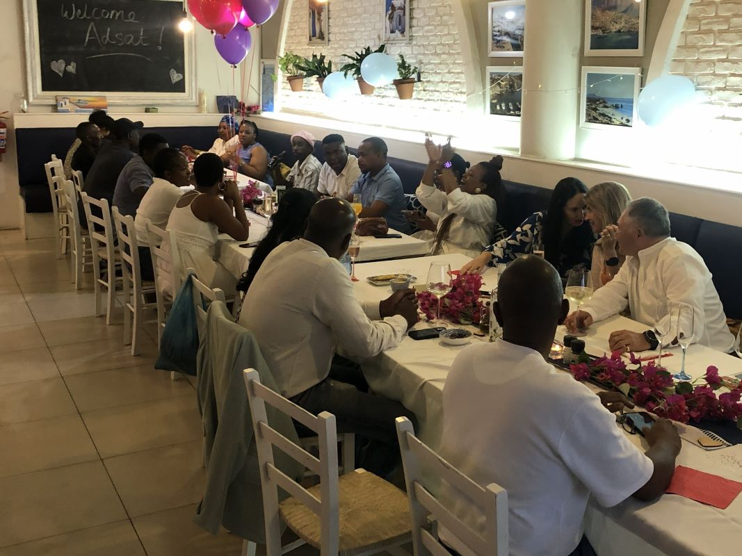 Long table celebration with balloons and a welcome board