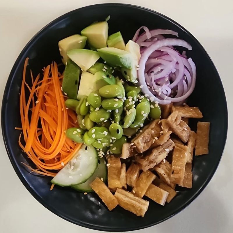Vegan poke bowl with tofu, edamame, avocado and carrot