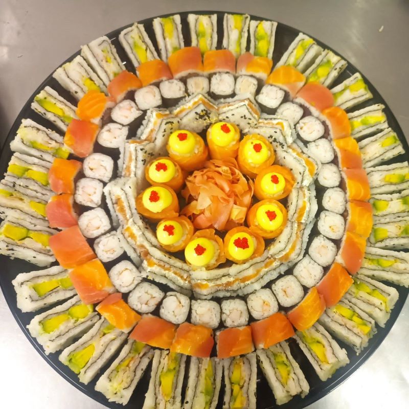 Large celebration sushi platter with salmon roses and fashion sandwiches