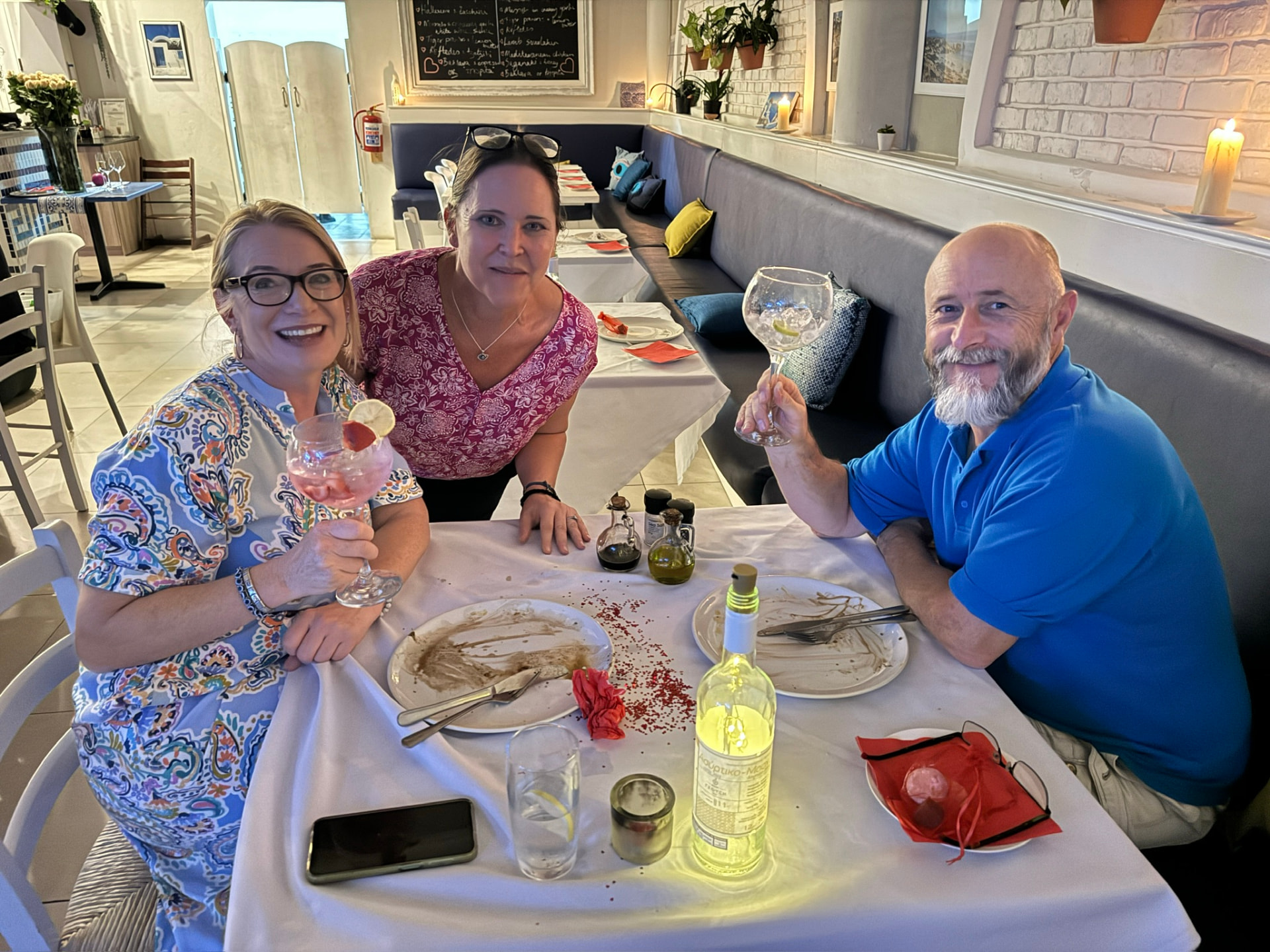 Friends raising gin glasses at a table