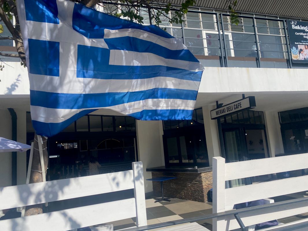 Greek flag flying outside Meraki Deli Cafe