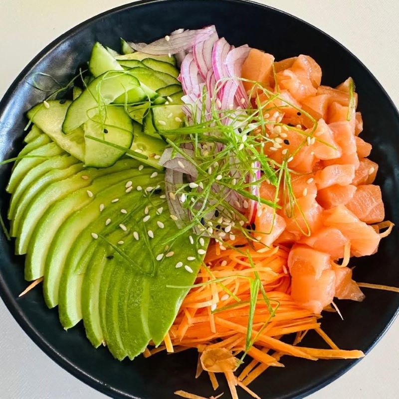 Salmon poke bowl with avocado, cucumber and carrot