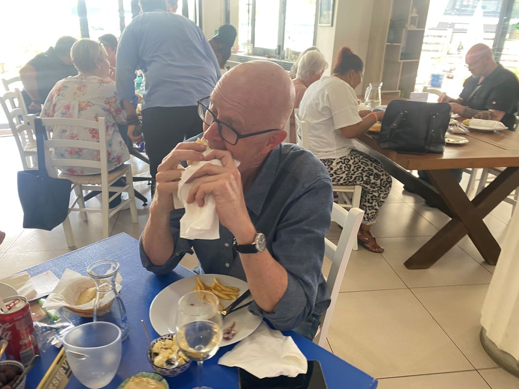 Guest enjoying a souvlaki wrap