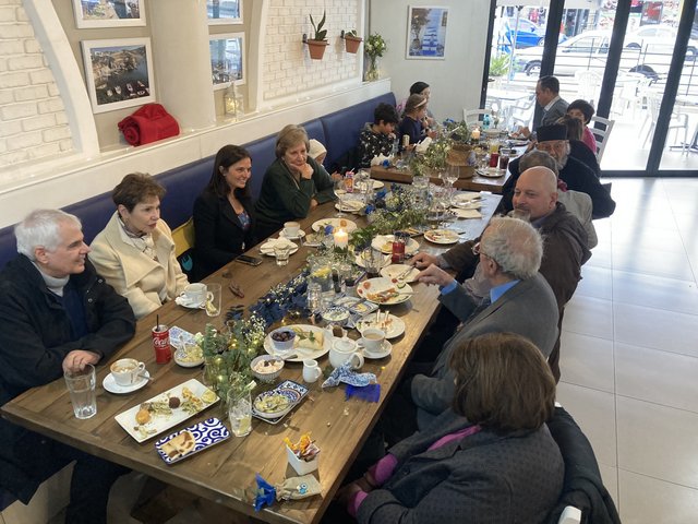 Long table lunch with guests sharing meze