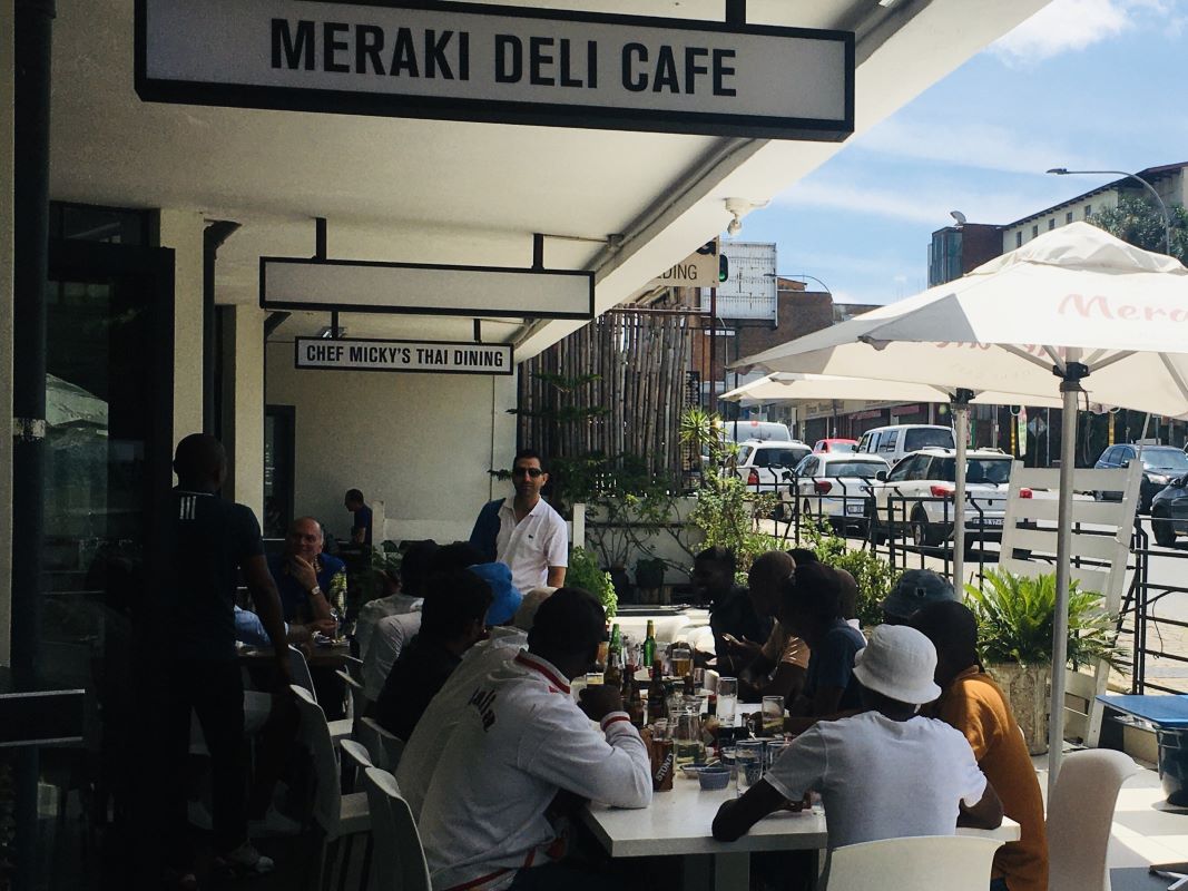 Guests dining on the pavement outside Meraki Deli Cafe