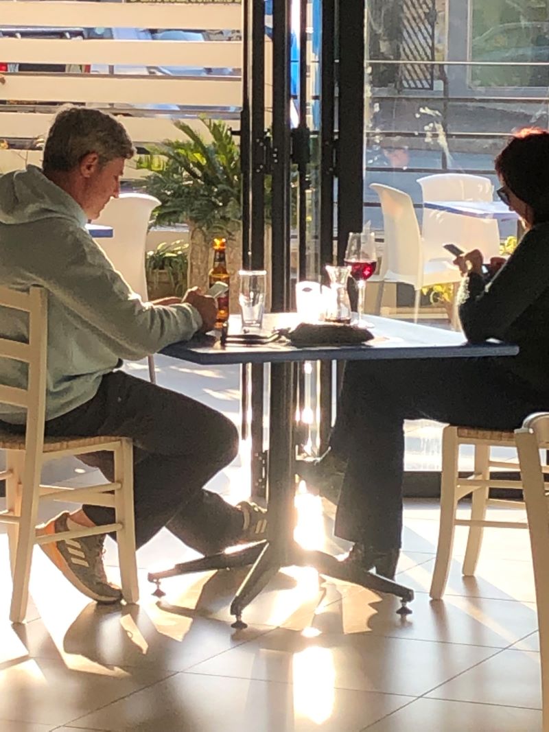 Couple relaxing with drinks in the afternoon sun