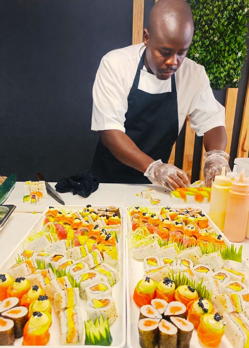 Sushi chef plating large event platters