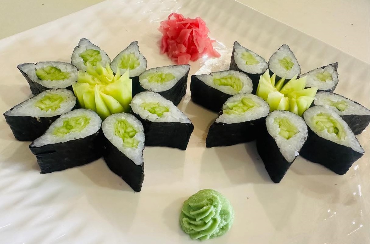 Cucumber maki arranged as flowers with pickled ginger and wasabi
